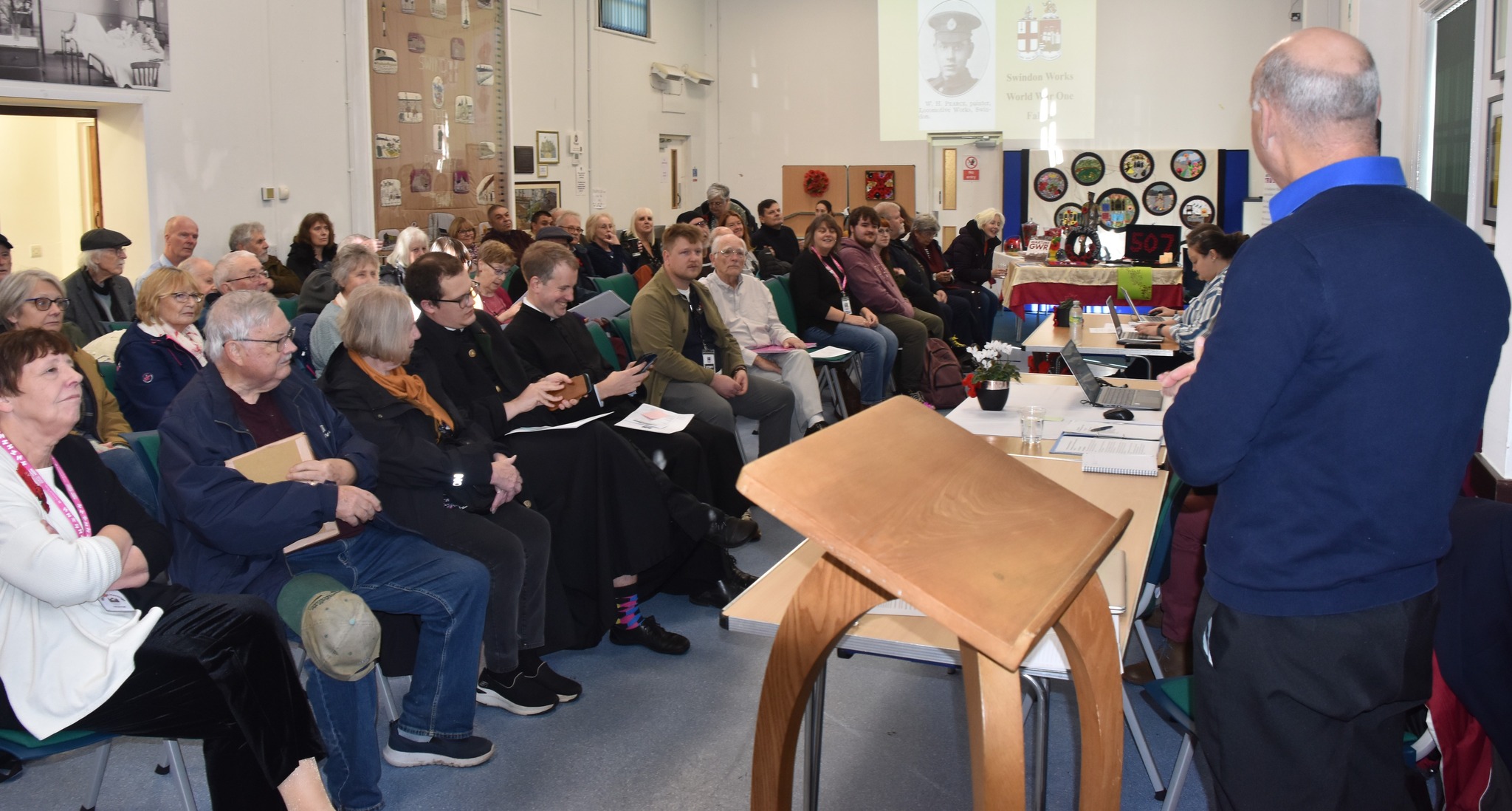 Room is filled with people Engaged with speakers at the AGM 2023