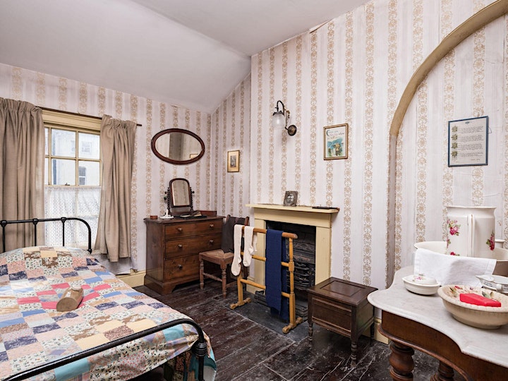 A Victorian bedroom with period furniture.